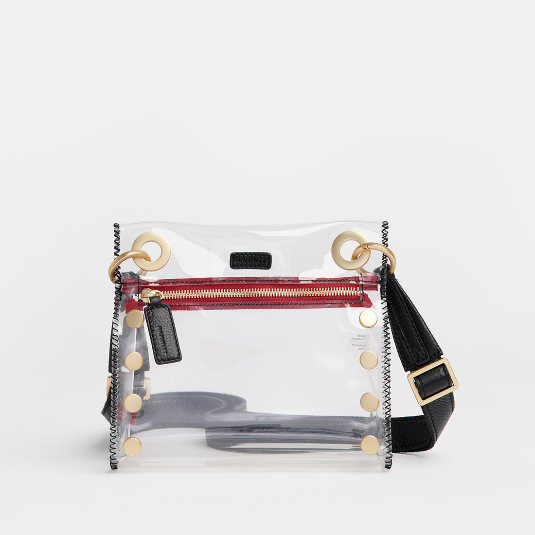 Tony Small Clear Bag with black leather strap, gold hardware, and red zipper detail.