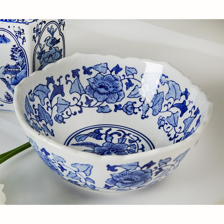 Blue and white Canton ceramic bowl with traditional floral patterns and a scalloped rim.