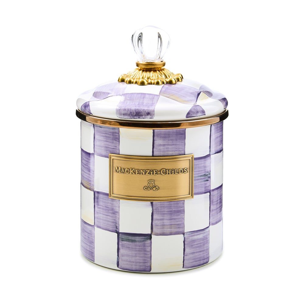 Small hand-glazed steel canister with violet checkered pattern, bronzed stainless rim, brass accents, and glass lid.