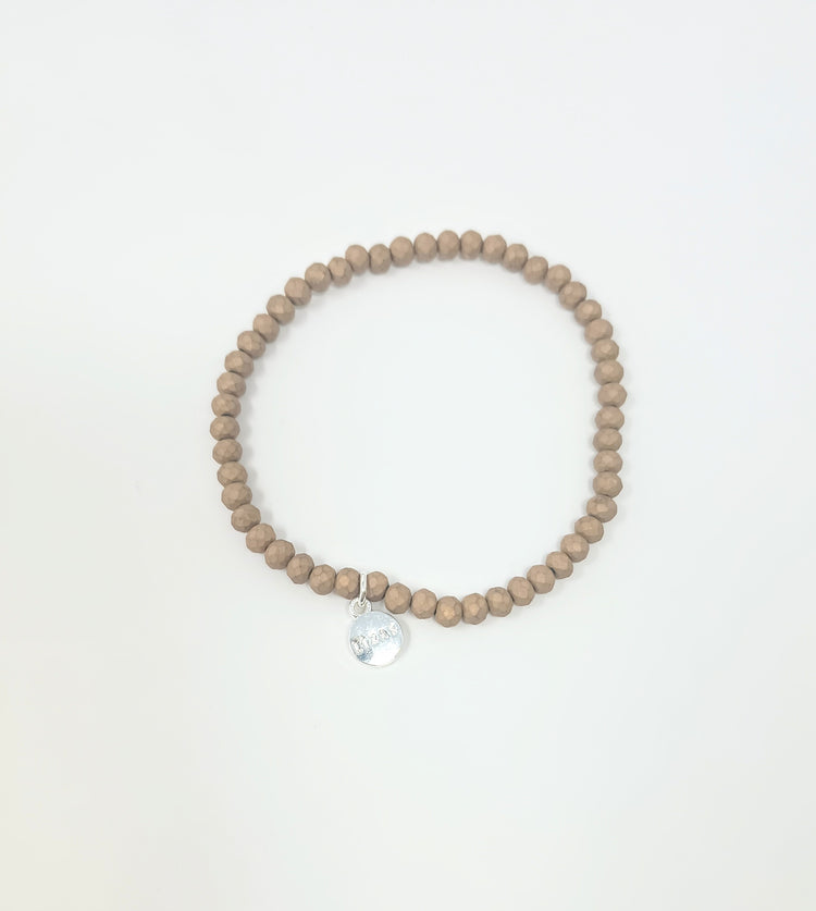 Stretchy bracelet with faceted glass beads in a colorful beaded pattern.