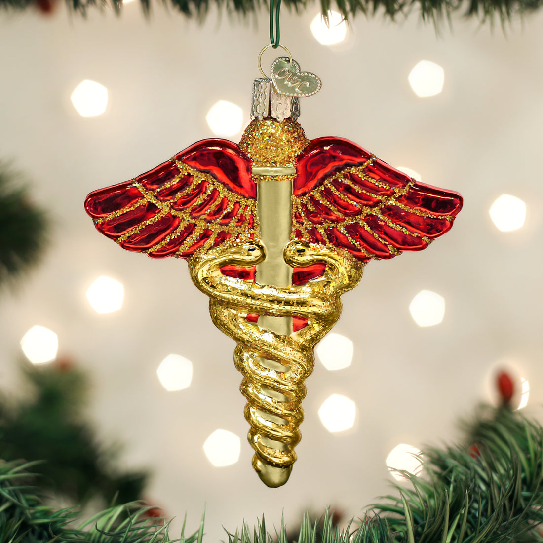 Small medical symbol ornament with a white cross on blue background.