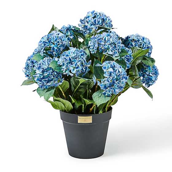 Blue artificial hydrangea urn filler in a dark grey pot with a gold logo plate.