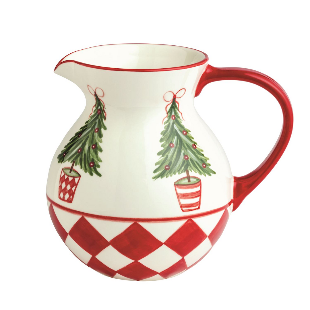 White ceramic pitcher with red handle, checkered base, and painted Christmas trees.